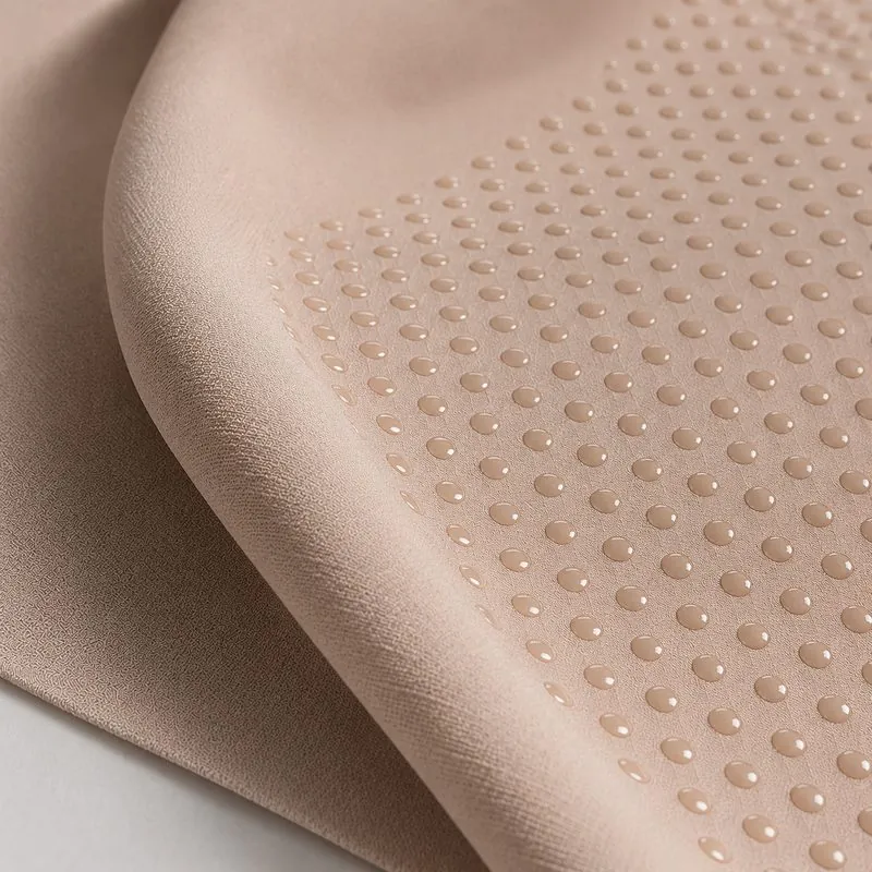 Close-up of hotmelt adhesive dots dispensed onto fabric